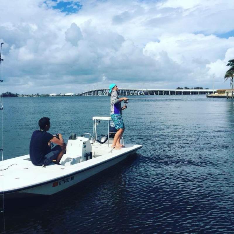 Two boys fishing in an inlet 